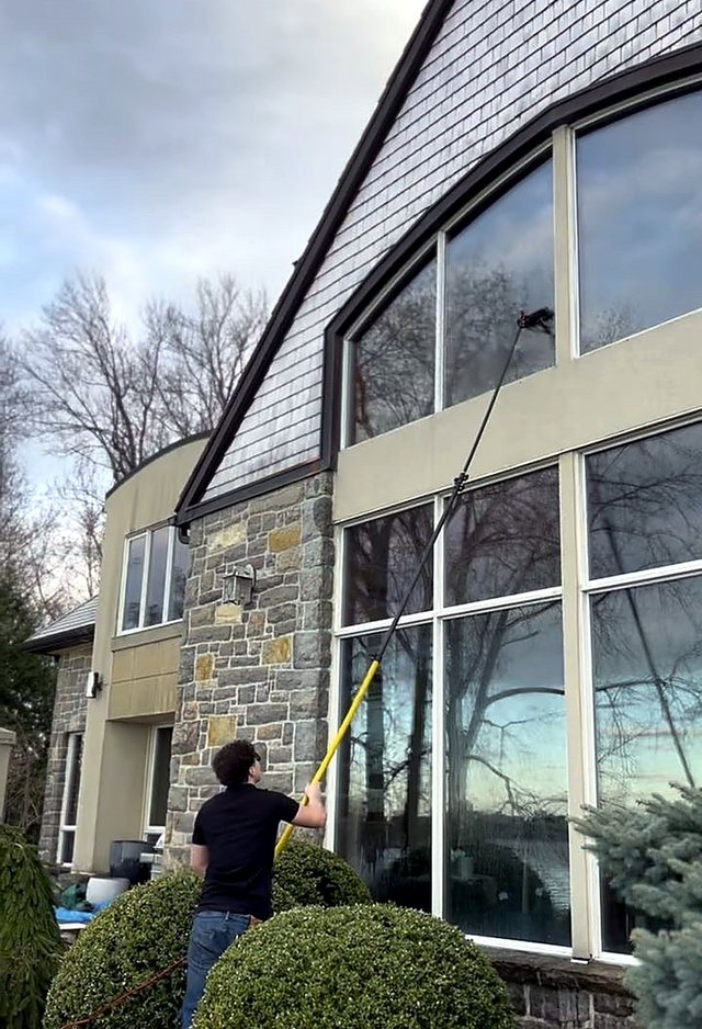 Arched glass on a stone-fronted home cleaned streak-free